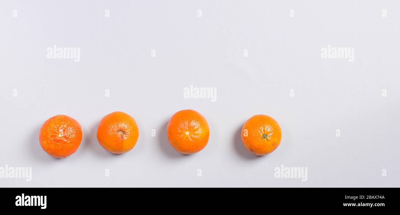 Three Fresh Oranges on Grey Background Stock Photo