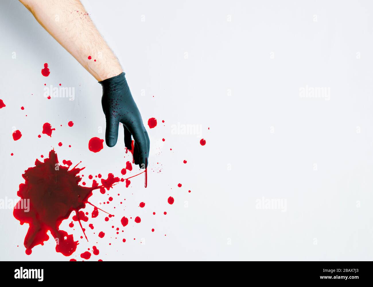 Gloved Hand with Blood Splatter on White Stock Photo