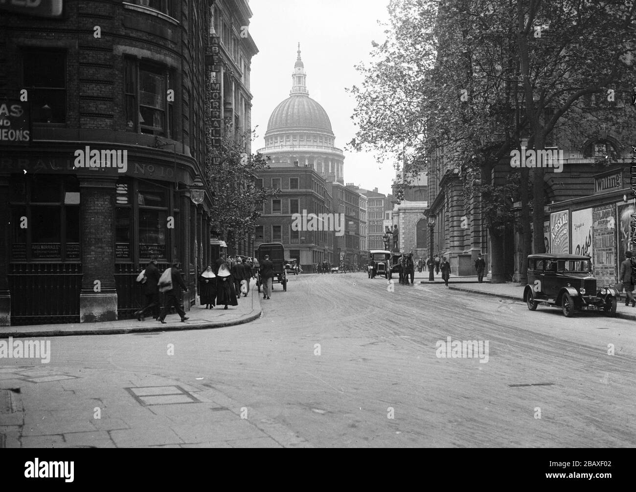 A street scene with St Paul's Cathedral in the background, London