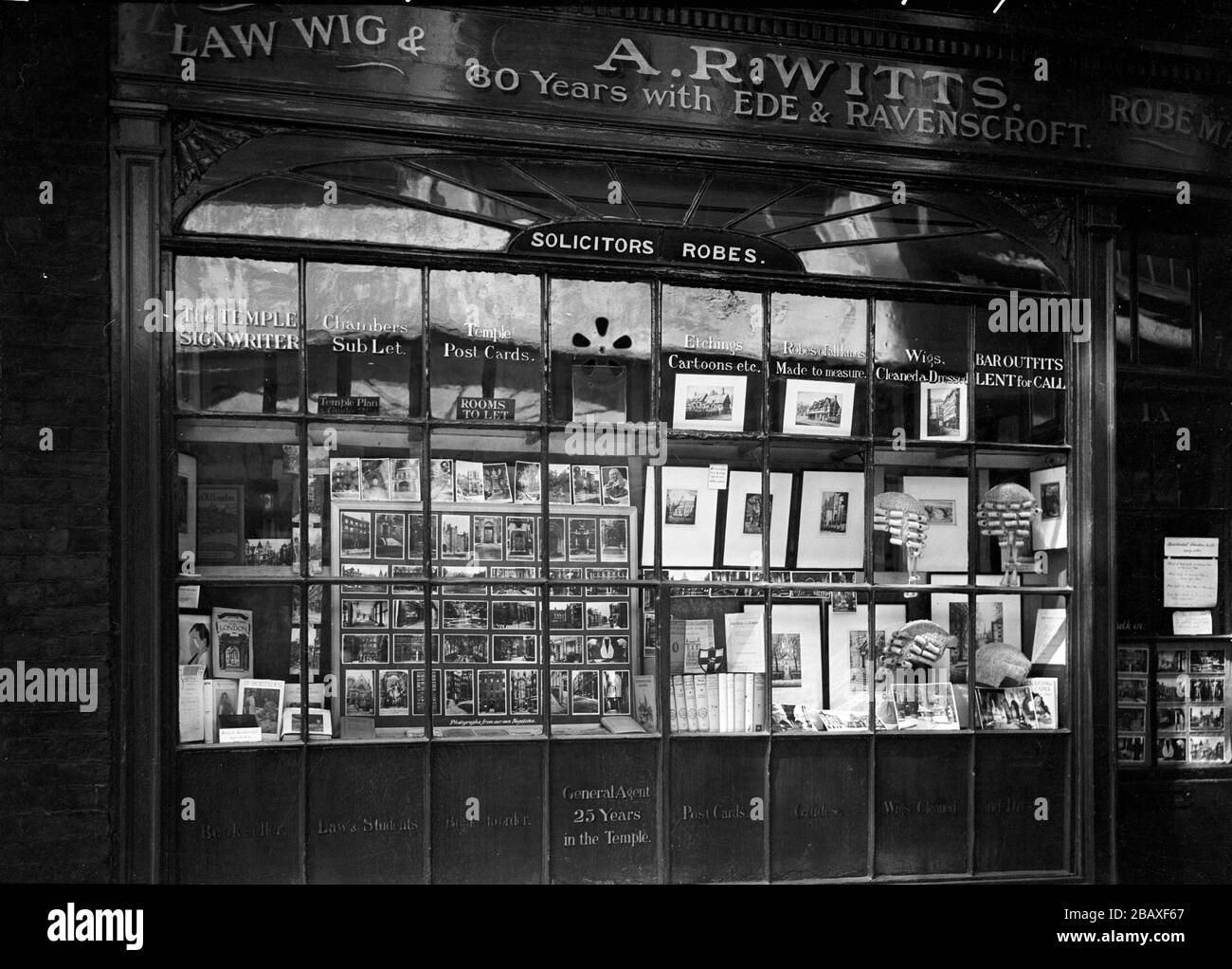 Exterior view of the window display and entrance to A.R. Witts, a judicial  supplies store selling law wigs and robes, London, England, United Kingdom,  1921. A sign on the store states '30