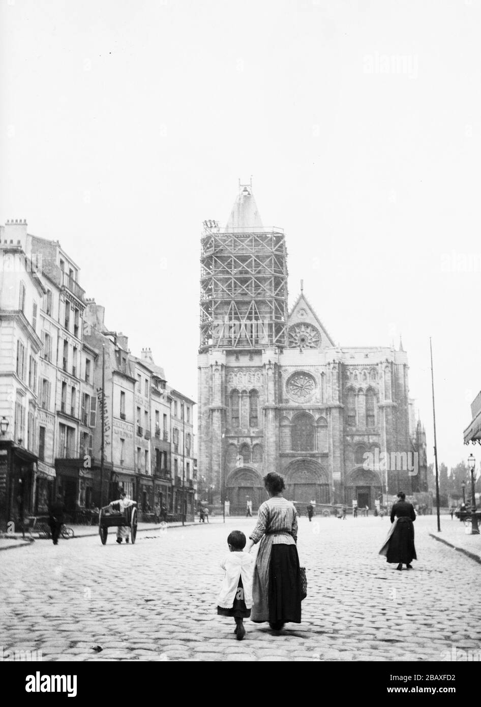Pedestrians walk on the cobblestone street leading to the Abbey Church