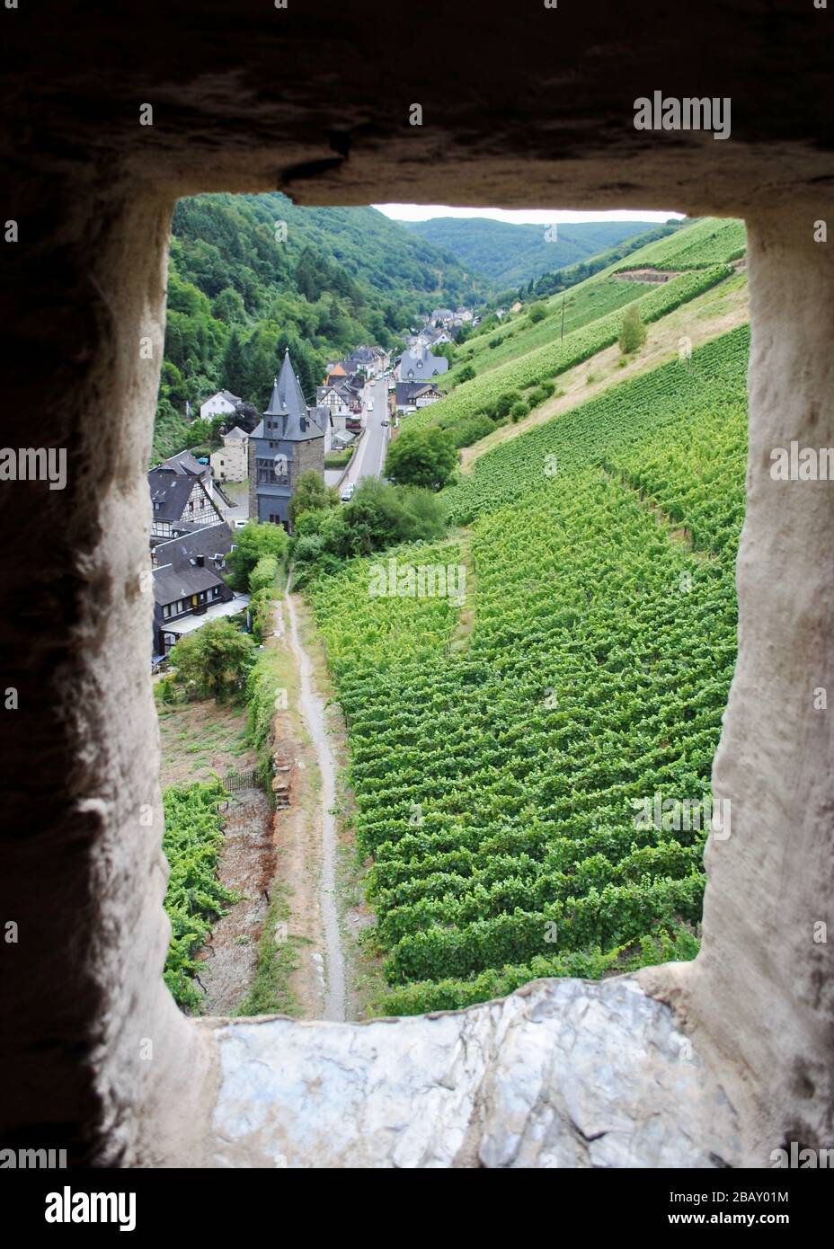 Looking out the Postenturm tower towards vineyards and grapevines and the Steeger Tor in Bacharach, Germany. Both towers were part of city's defense. Stock Photo