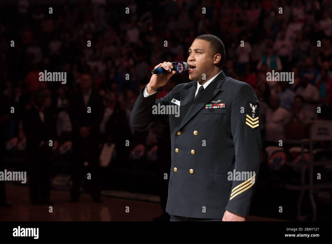 '170404-N-HG258-064 WASHINGTON, D.C. (April 4, 2017) Musician 1st Class Cory Parker, vocalist for the U.S. Navy Band, sings the National Anthem at a Washington Wizards NBA game held at the Verizon Center in Washington, D.C. (U.S. Navy photo by Senior Chief Musician Stephen Hassay/Released); 4 April 2017, 18:05; National Anthem at Wizards NBA Game; United States Navy Band from Washington, D.C., USA; ' Stock Photo