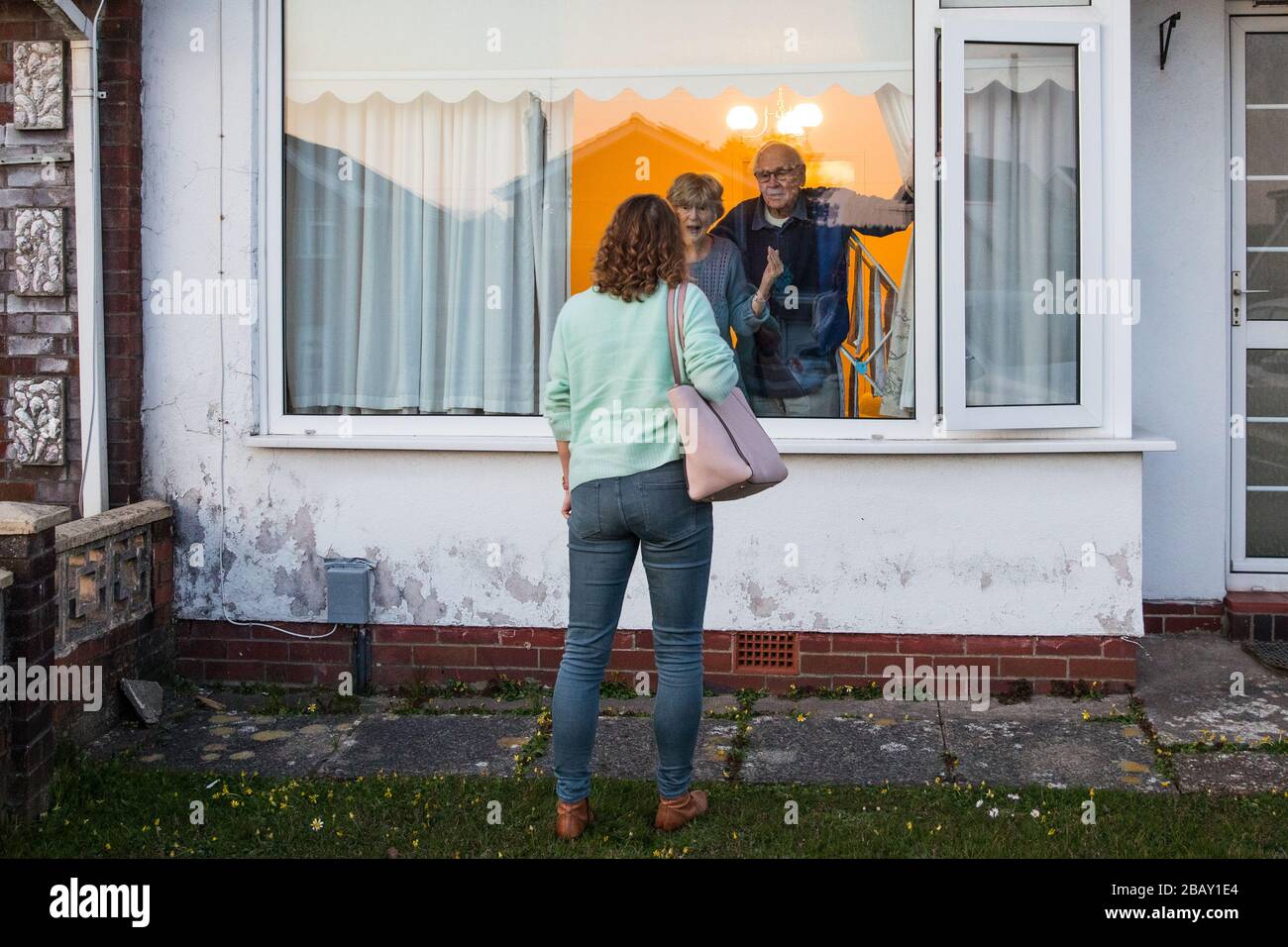 Author, Tracy Rees visits her vulnerable elderly parents to deliver groceries during the isolation period due to the COVID-19 coronavirus pandemic.The British government has advice all its residents to stay home and only to go outside for food or health reasons. The United Kingdom has reported over 19,500 cases of the Coronavirus and caused over 1000 deaths. Stock Photo
