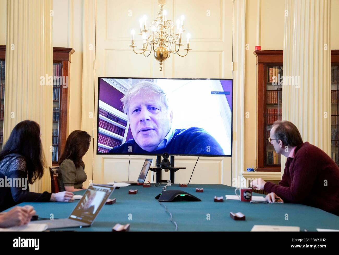 (200329) -- LONDON, March 29, 2020 (Xinhua) -- British Prime Minister Boris Johnson (C) chairs a morning COVID-19 update meeting remotely during his self-isolation after testing positive for COVID-19, in London, Britain, on March 28, 2020. A total of 19,522 COVID-19 cases have been confirmed in Britain as of Sunday morning, marking an increase of 2,433 in the past 24 hours, according to the Department of Health and Social Care. (Andrew Parsons/No 10 Downing Street/Handout via Xinhua) (EDITORIAL USE ONLY) Stock Photo