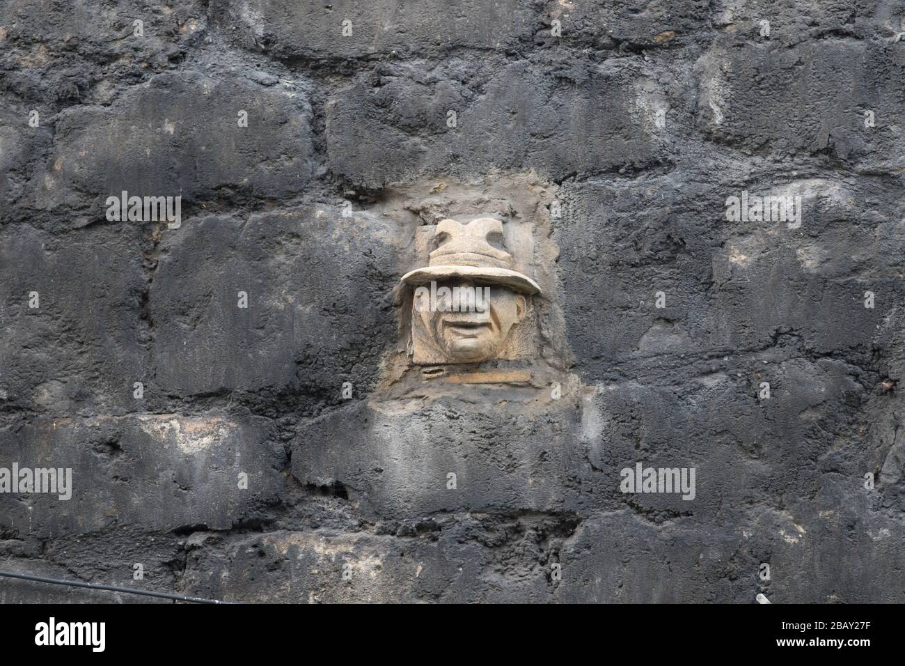 A stone face from The Great Wall of Walcot project in Walcot Street, Bath, United Kingdom. Stock Photo