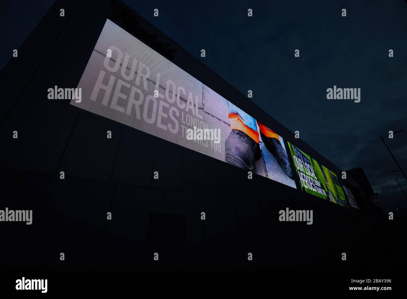 London, U.K. - 29 Mar 2020: A giant illuminated billboard in west London praises essential workers for their help during the coronavirus pandemic. Stock Photo