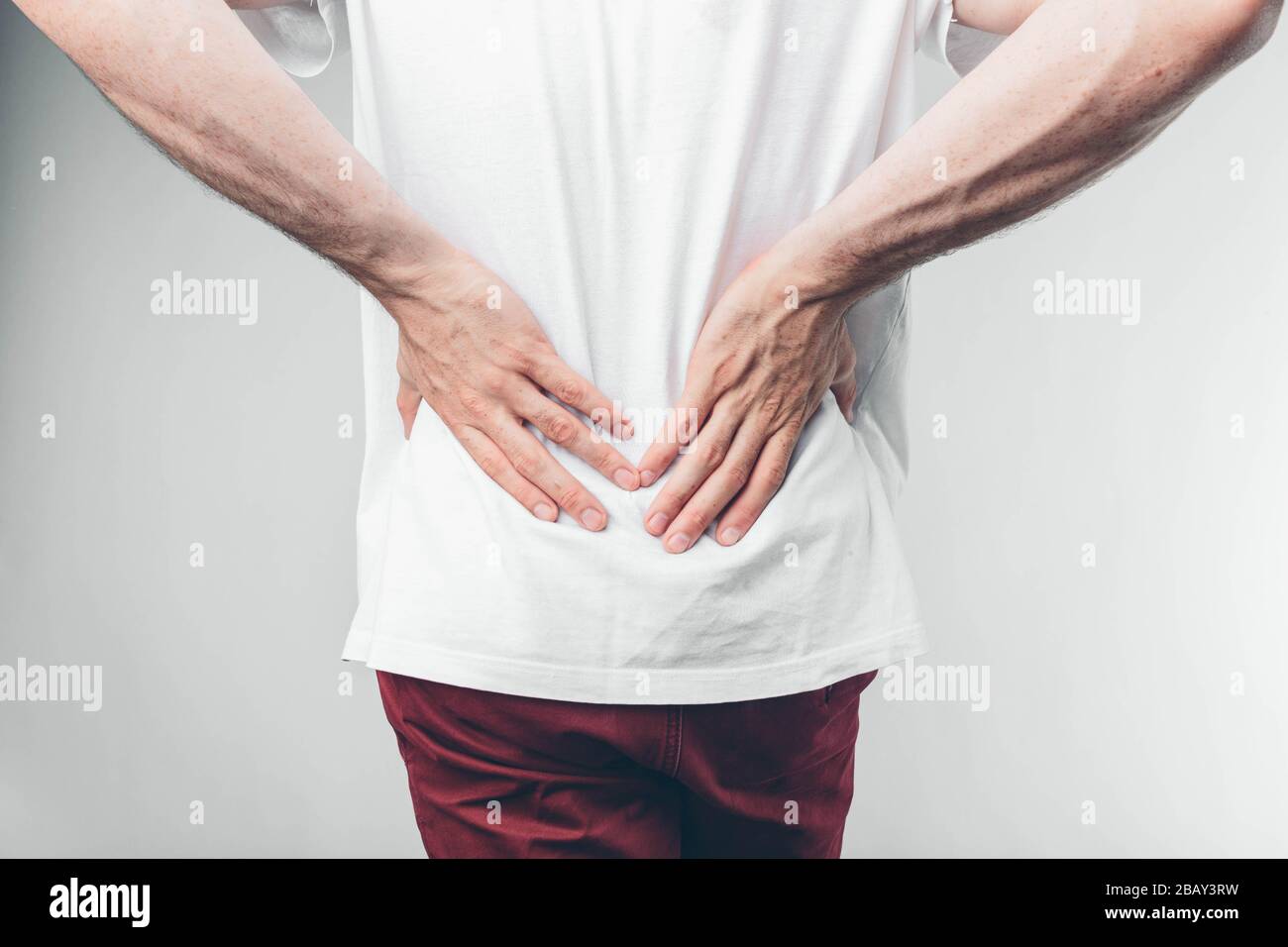 Caucasian Man in White T-shirt and Burgundy Pants. Holding His Hands on  Stomach. Cut View. Concept Stock Image - Image of discomfort, hand:  177276149