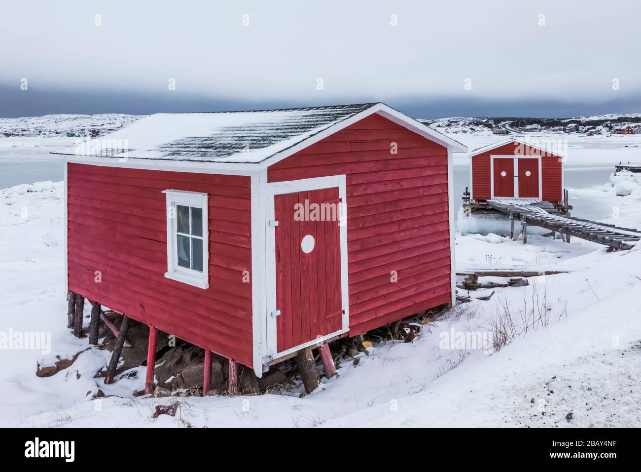 Red stages on the snowy shore of Joe Batt's Arm on Fogo Island in