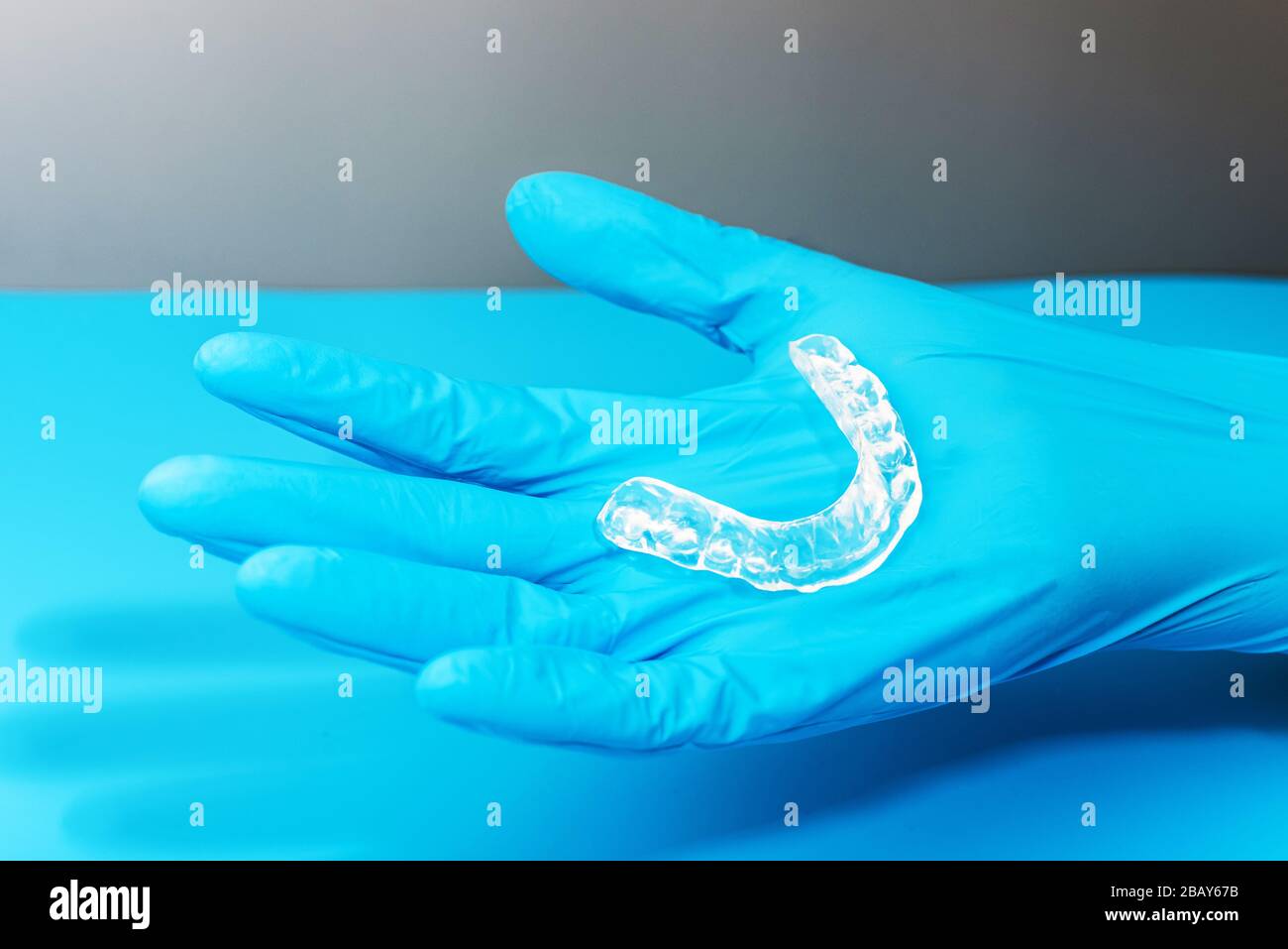 Dentist holds occlusal splint used to reduce nighttime bruxism. Stock Photo