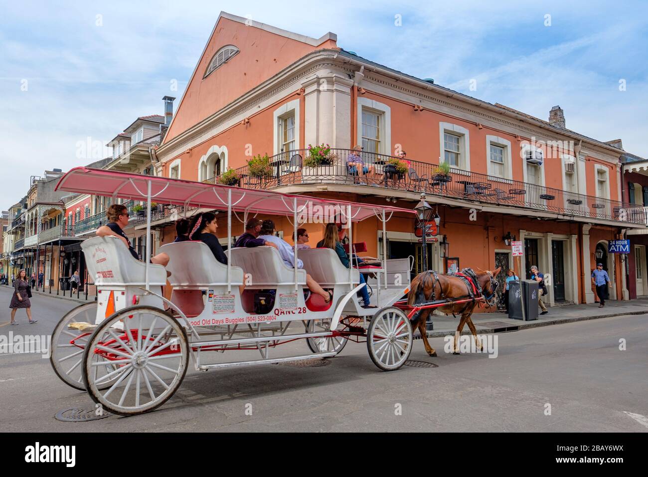 Tourists taking a horse drawn cart guided tour on streeet of old New Orleans French Quarter New Orleans, Louisiana, USA. Stock Photo