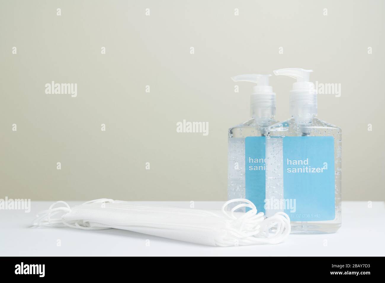Two hand sanitizer in plastic bottle and surgical face masks Stock ...
