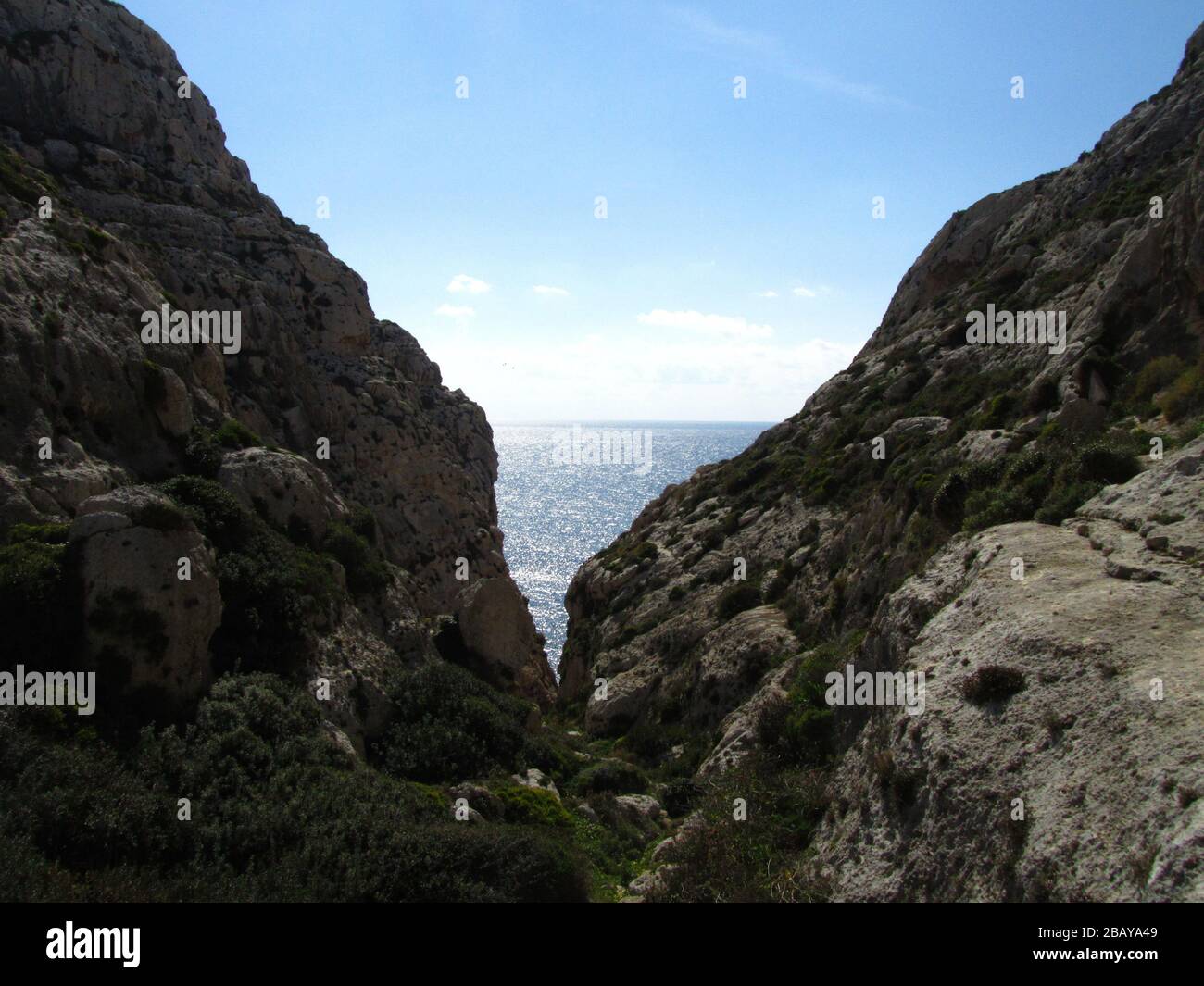 Ocean view between big coastal rocks Stock Photo - Alamy