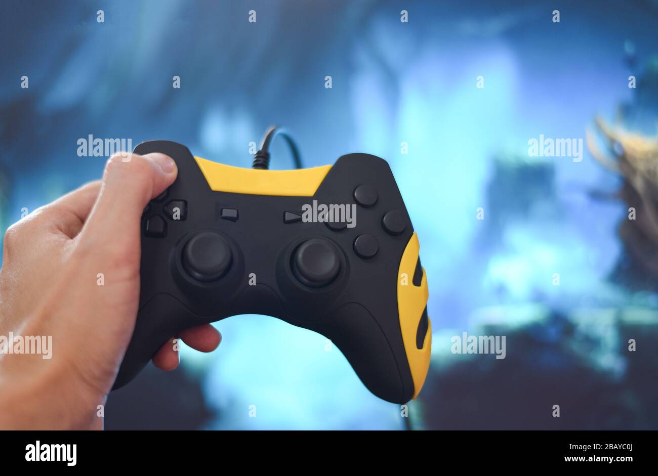 Gamer and guy controller with game pad joystick on hand playing gaming and  watching video on tv or Computer games console / The boy holding hobby play  Stock Photo - Alamy