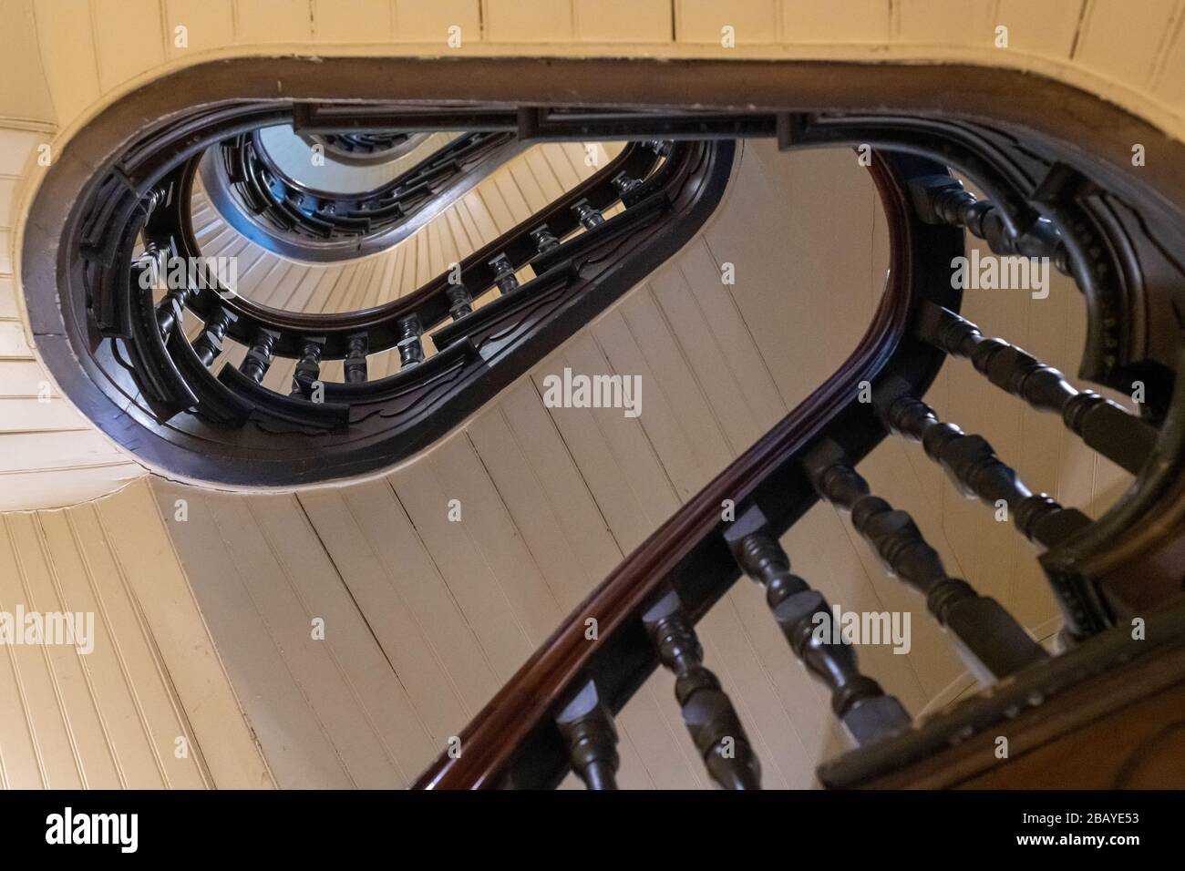 Look up a curved stairway in The Block. Stock Photo