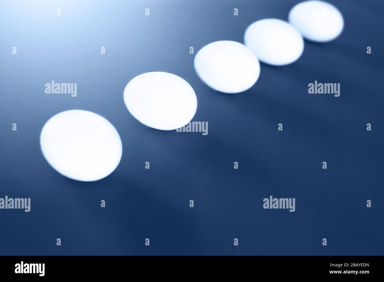 Five easter white eggs on blue background. Easter concept. Stock Photo