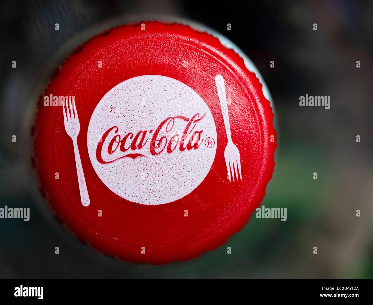 In this photo illustration a Coca-Cola logo seen displayed on a bottle
