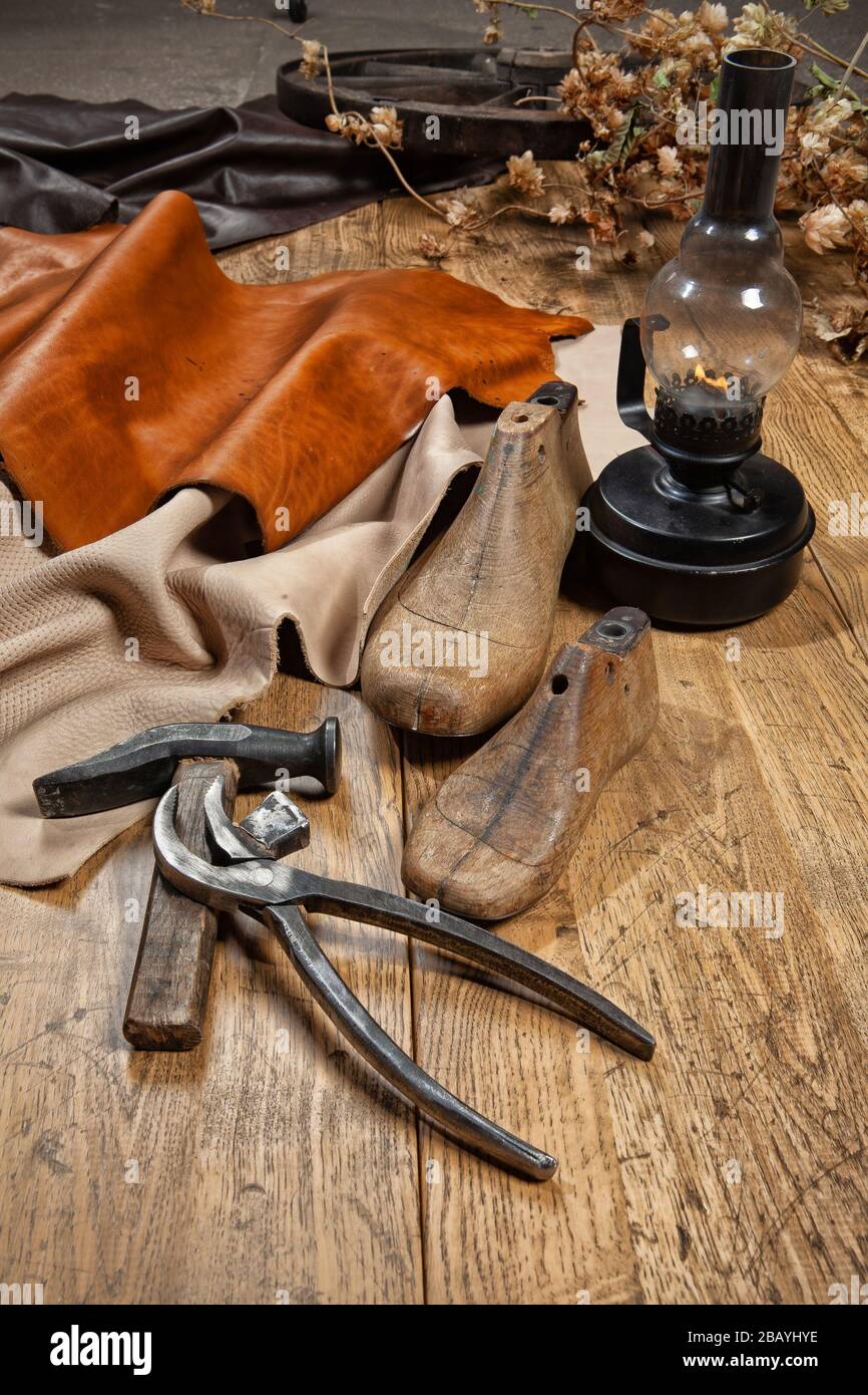 Shoes shoemaking tools and pieces of leather on a studio