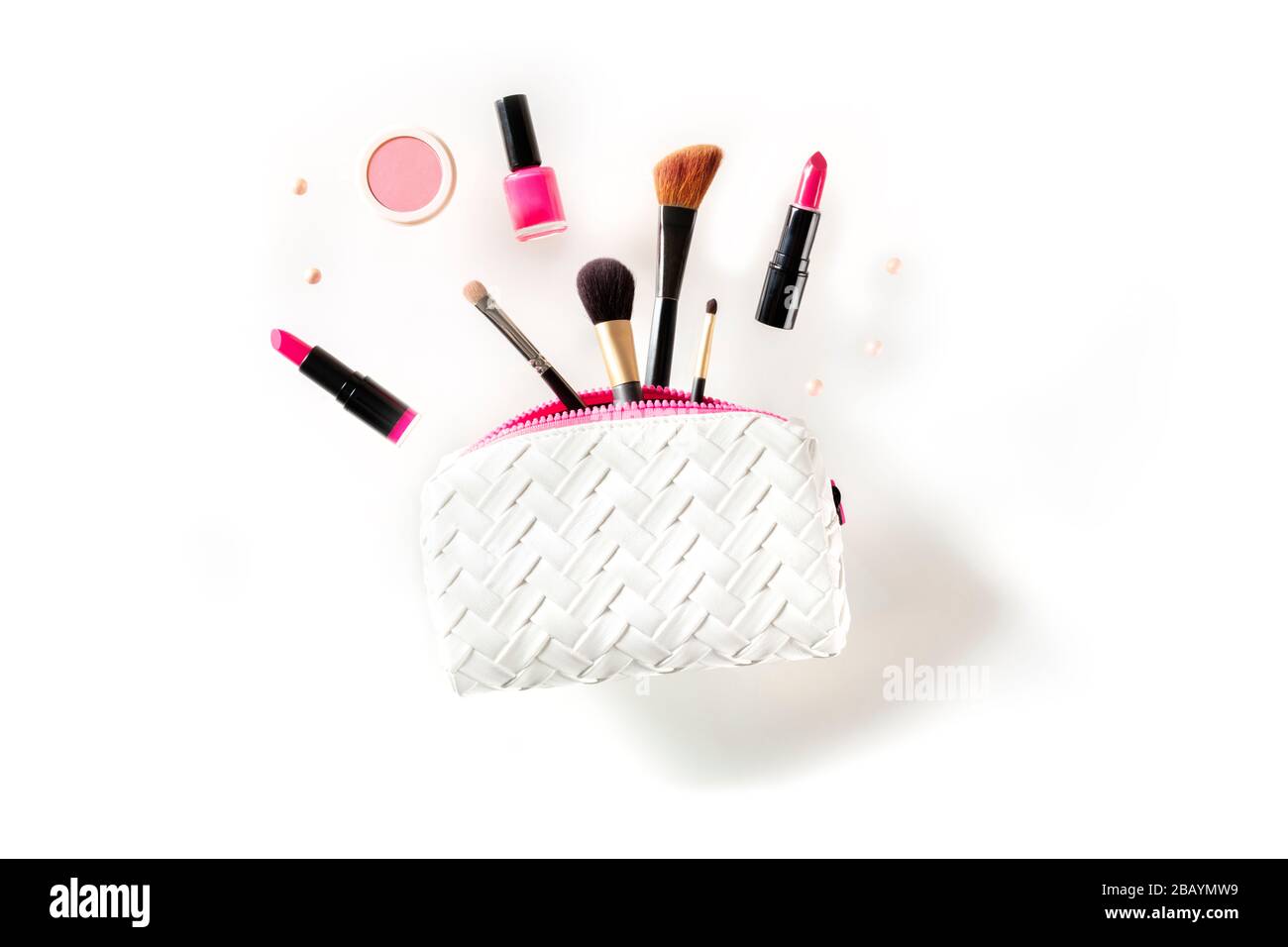 Professional makeup, flying out of a pouch, on a white background Stock