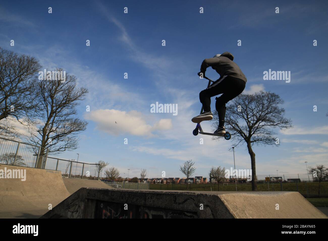 Youth scooter rider, england, uk, skate, skatepark, ramps, tricks