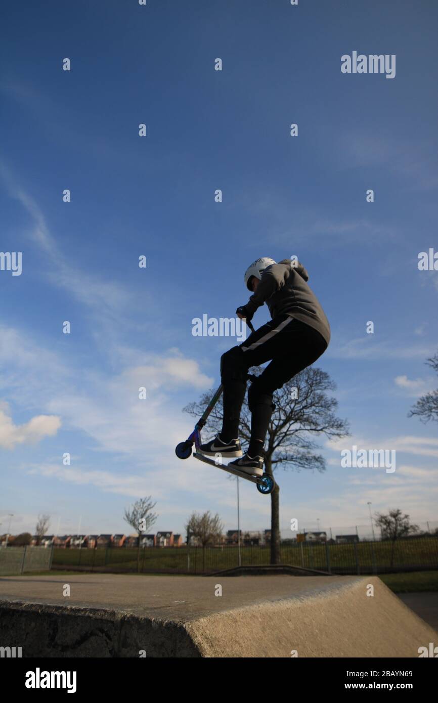 Youth scooter rider, england, uk, skate, skatepark, ramps, tricks