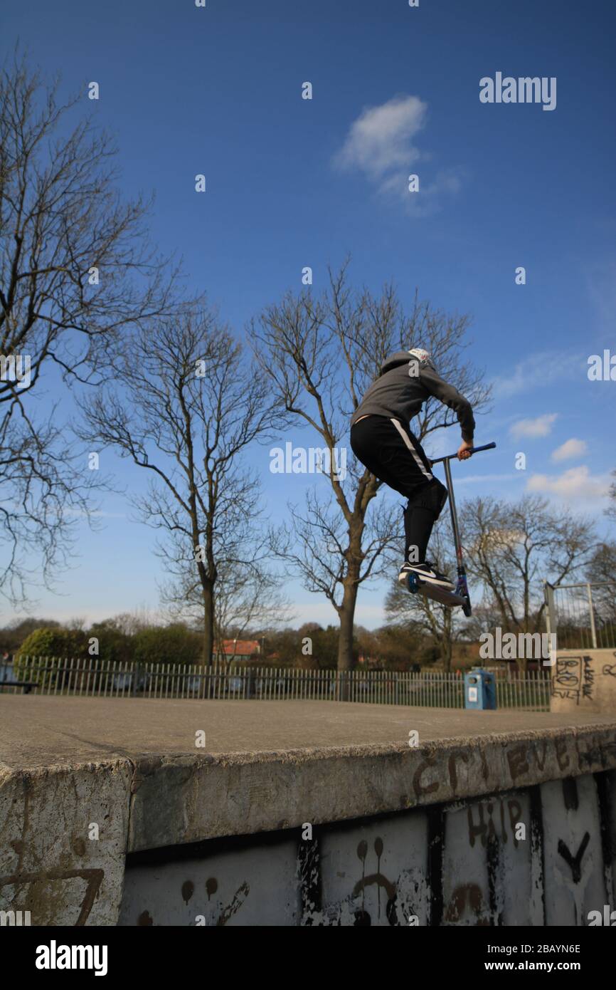 Youth scooter rider, england, uk, skate, skatepark, ramps, tricks