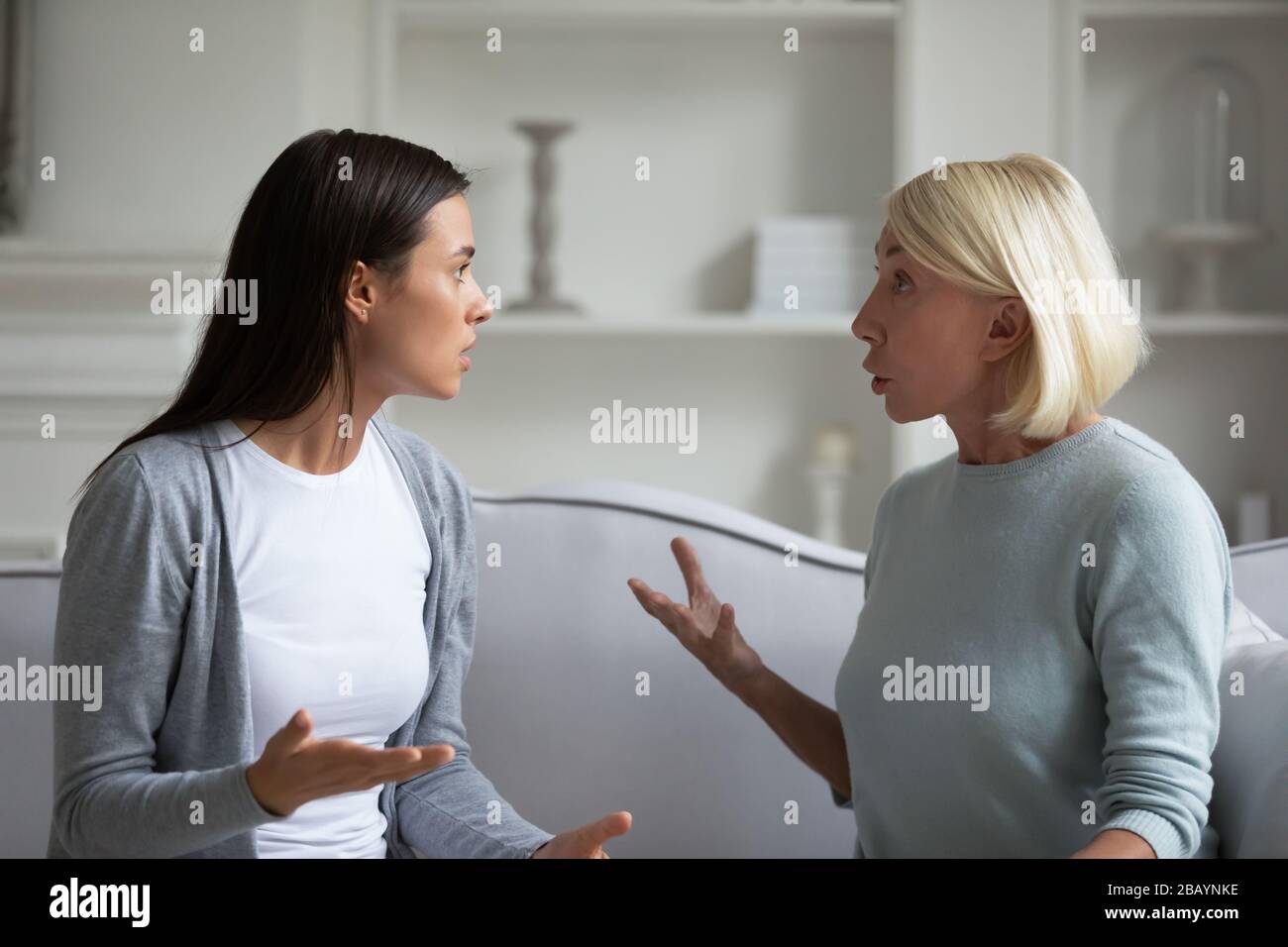 Mature mom and adult daughter have fight at home Stock Photo