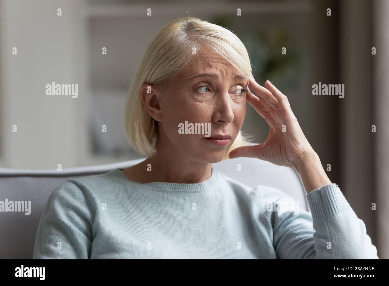 Distressed elderly woman feel lonely at home Stock Photo