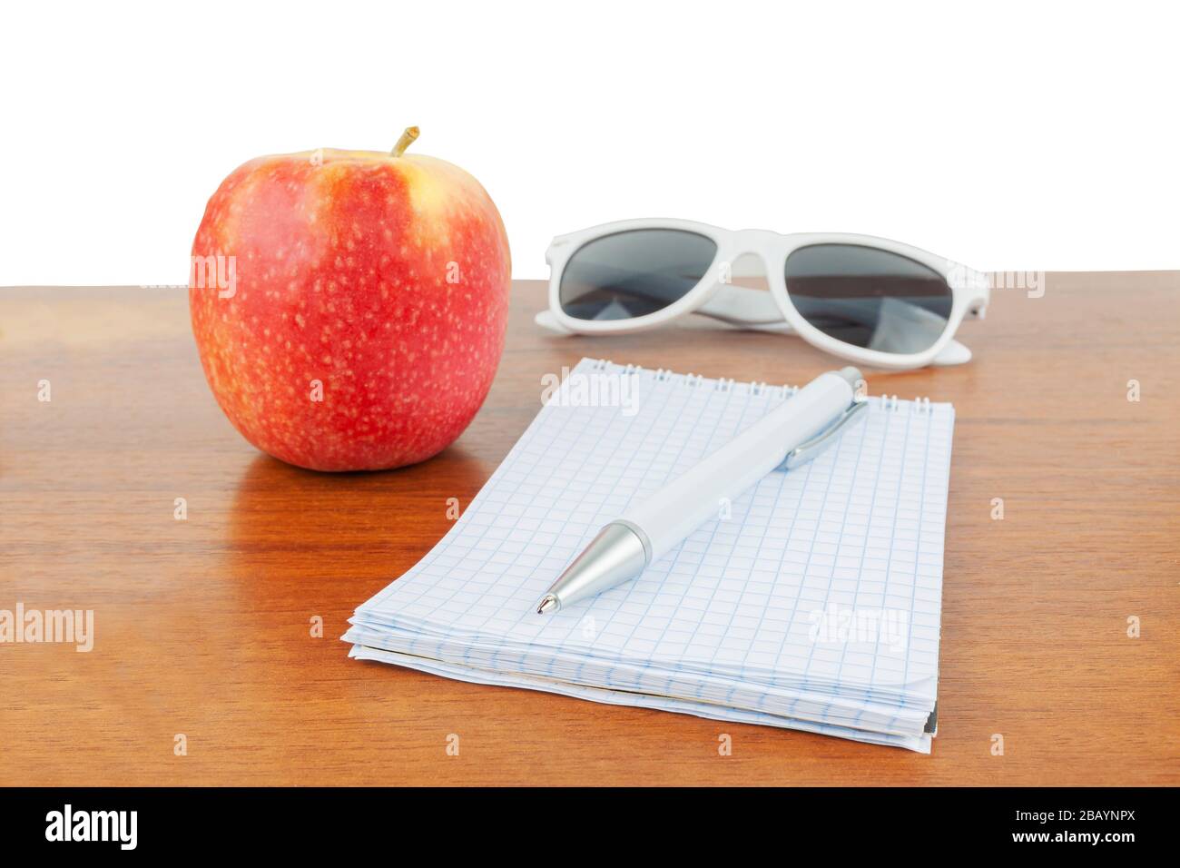 Apple glasses handle notepad lie on the table. Stock Photo