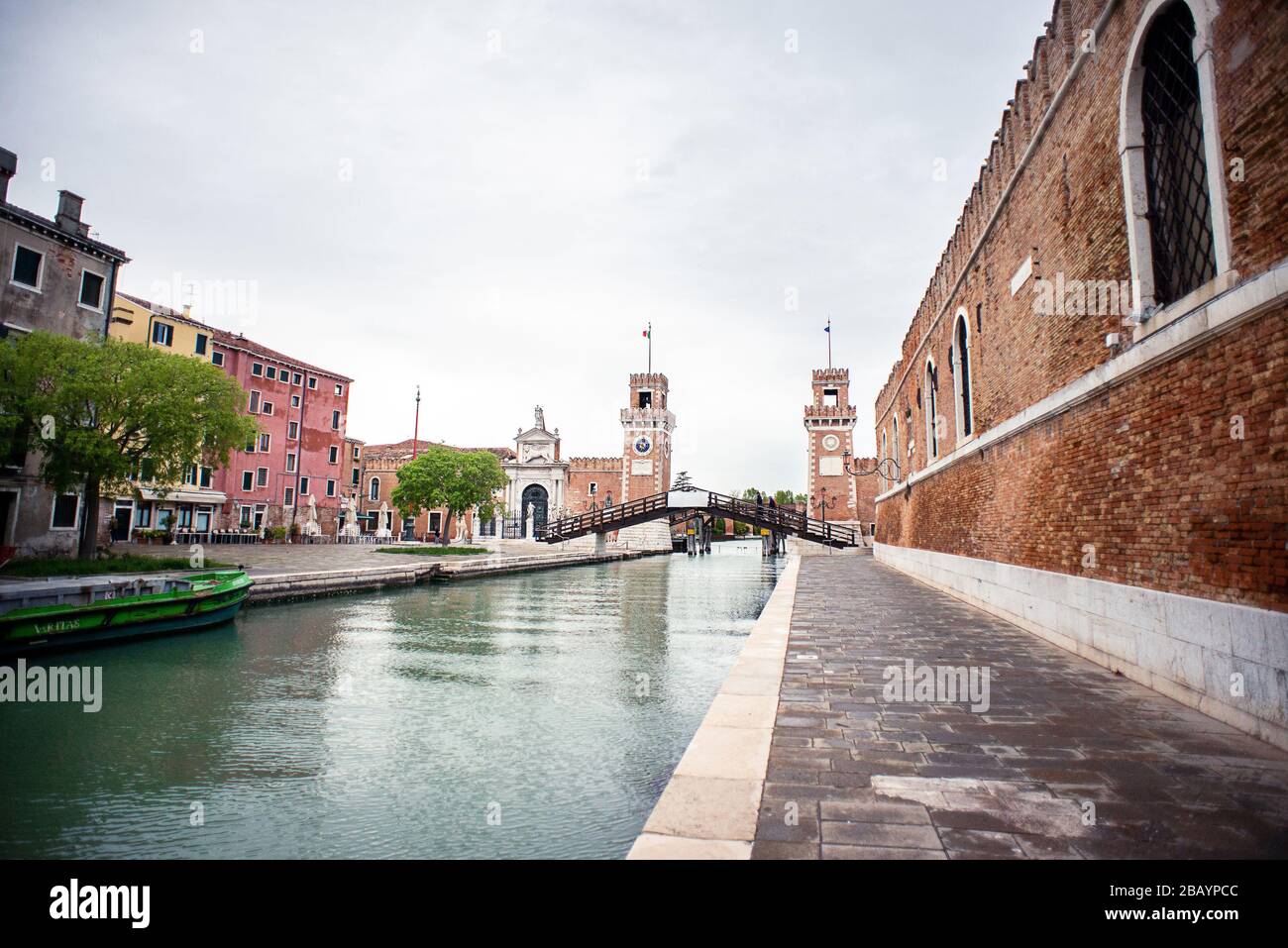 Venice. Italy - May 13, 2019: The Main Gate at the Venetian Arsenal (Arsenale di Venezia). Ponte del Paradiso. Canal Rio dell Arsenale. Cloudy Sky. Stock Photo