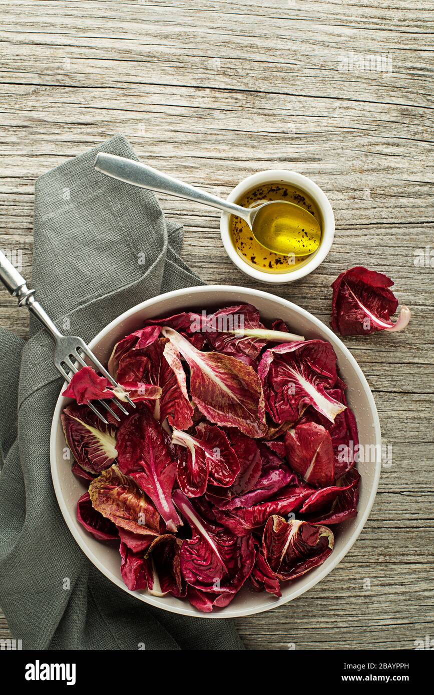 Healthy red lettuce salad meal on wooden table background. Freshly picked radicchio Stock Photo