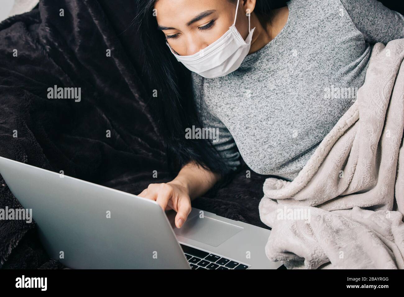 Coronavirus outbreak. Woman in despair watching number of cases and death toll of coronavirus  Covid-19 pandemic. Stock Photo