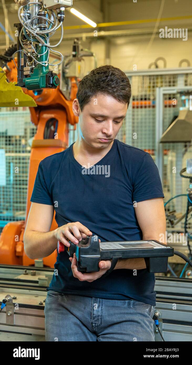 control the robotic arm using the remote control Stock Photo Alamy