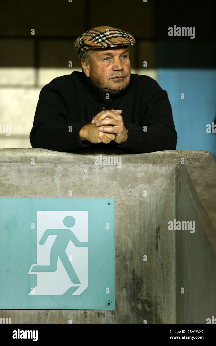 A Millwall fan wearing a Burberry flat cap watches from the stands Stock  Photo - Alamy