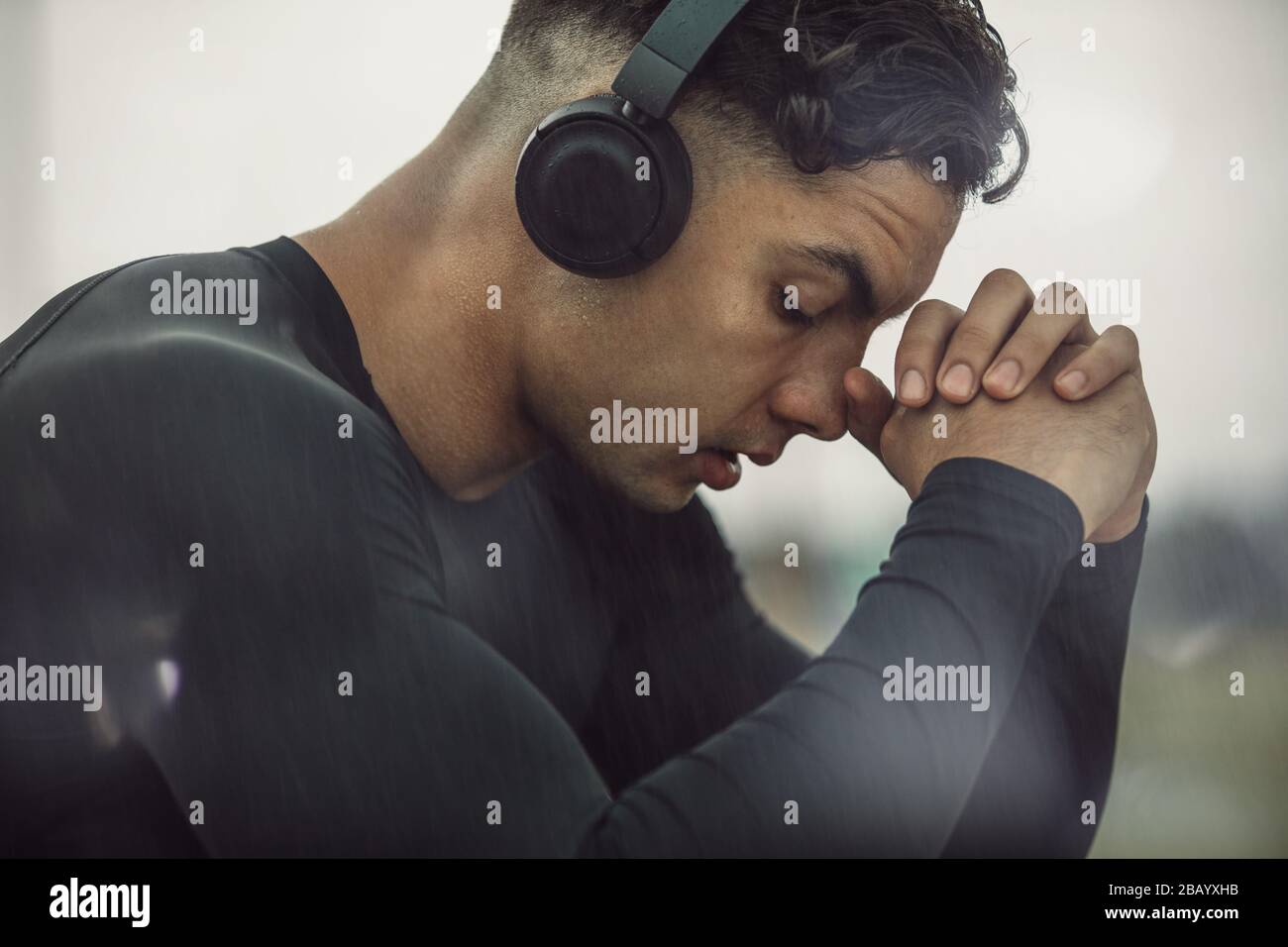 Young Man In Sportswear With Headphones Taking A Break Young Man Feeling Tired After Intense 