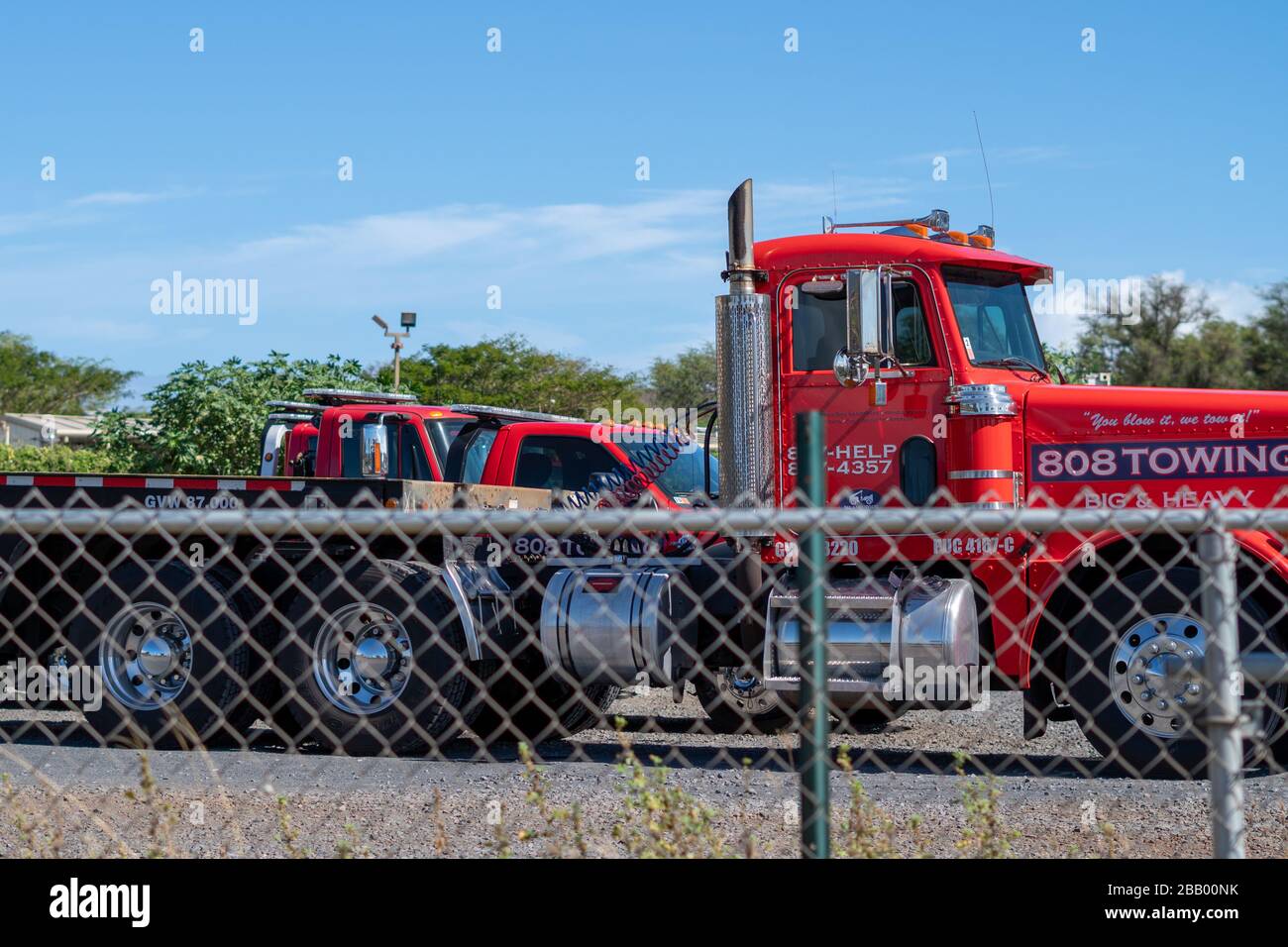 Due to decreased auto usage, normally busy tow trucks are parked without work in Maui, Hawaii during Covid-19 Pandemic Stock Photo
