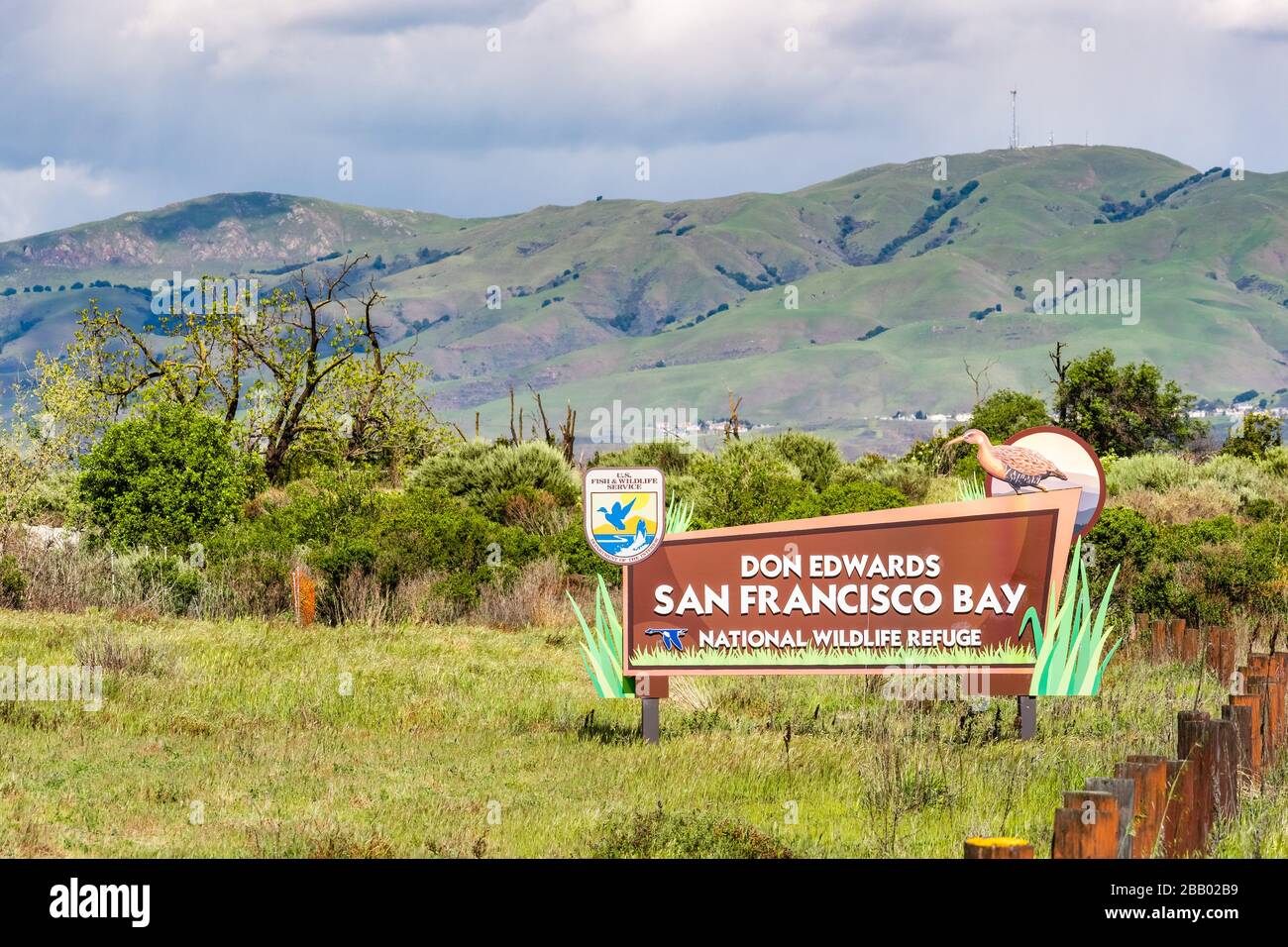 March 26, 2020 San Jose / CA / USA - Don Edwards San Francisco Bay National Wildlife Refuge sign displayed at the entrance; mountains visible in the b Stock Photo
