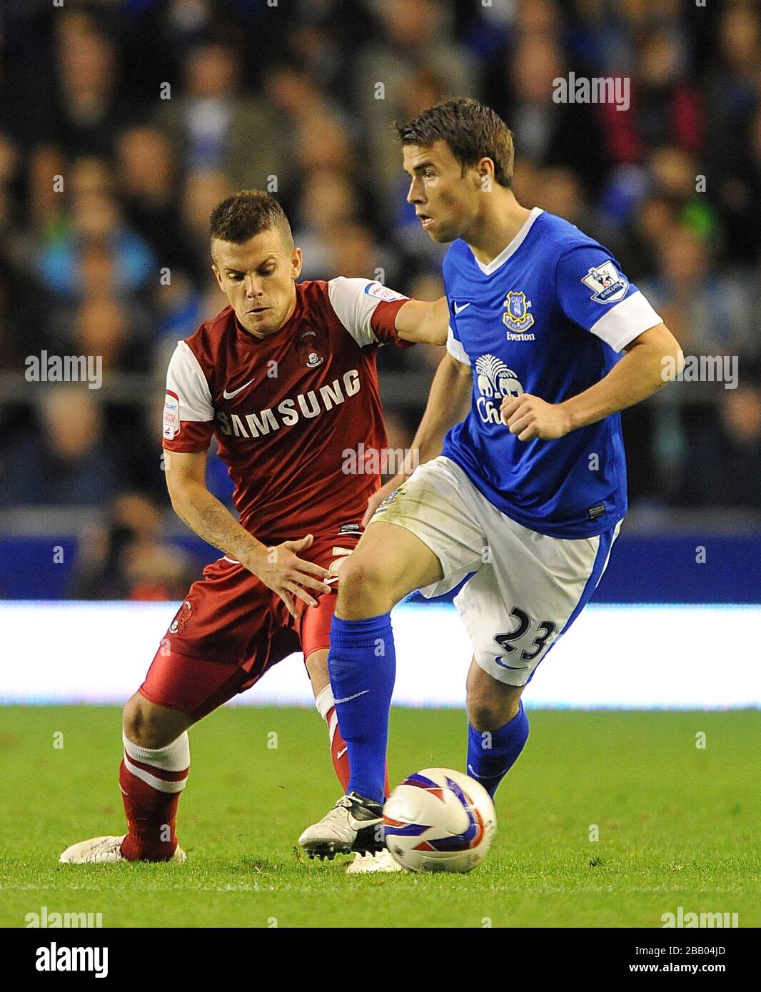 Leyton Orient's Dean Cox (left) and Everton's Seamus Coleman battle for the ball Stock Photo