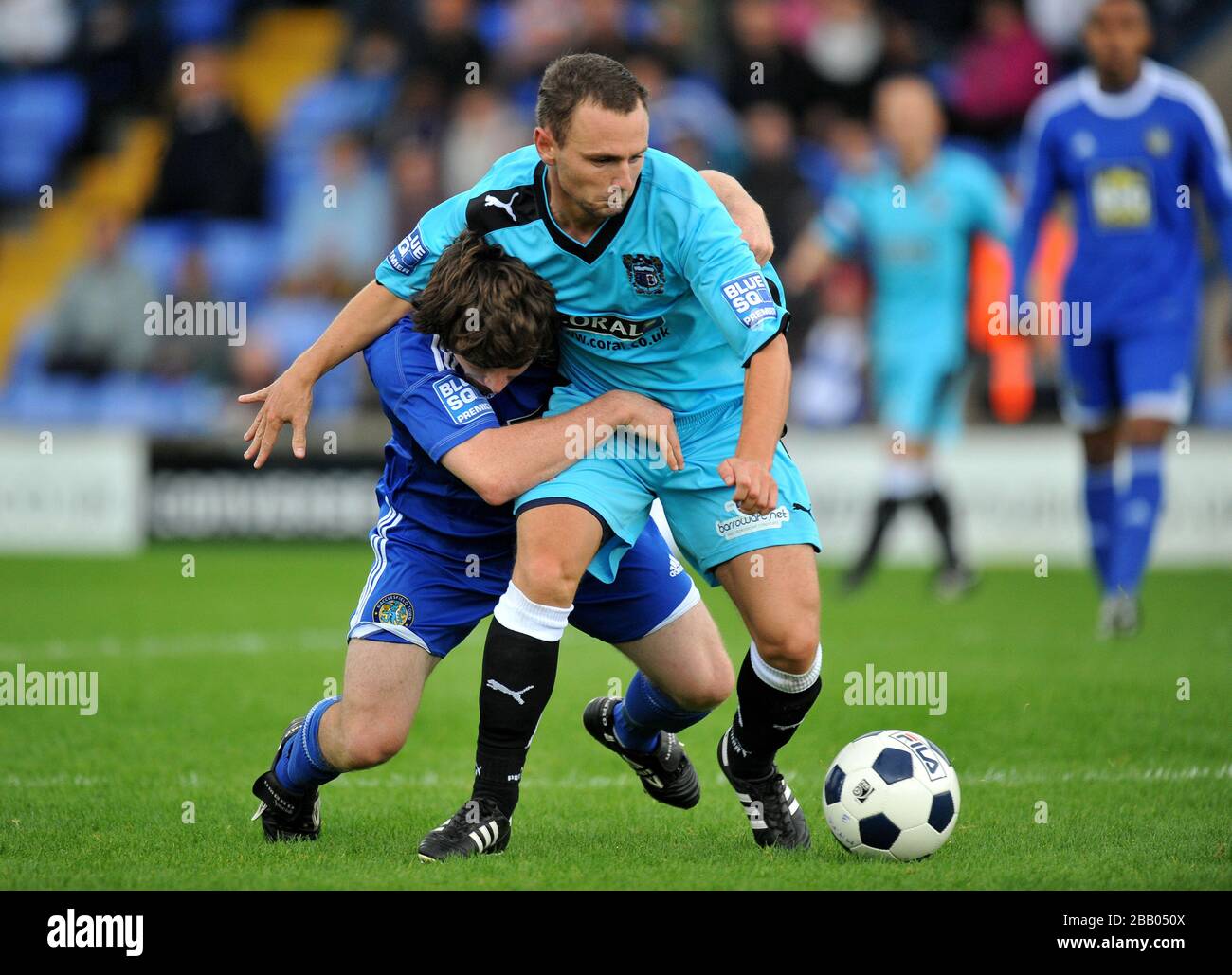 Macclesfield Town's John Paul Kissock tackles Barrow's Gary Hunter Stock Photo