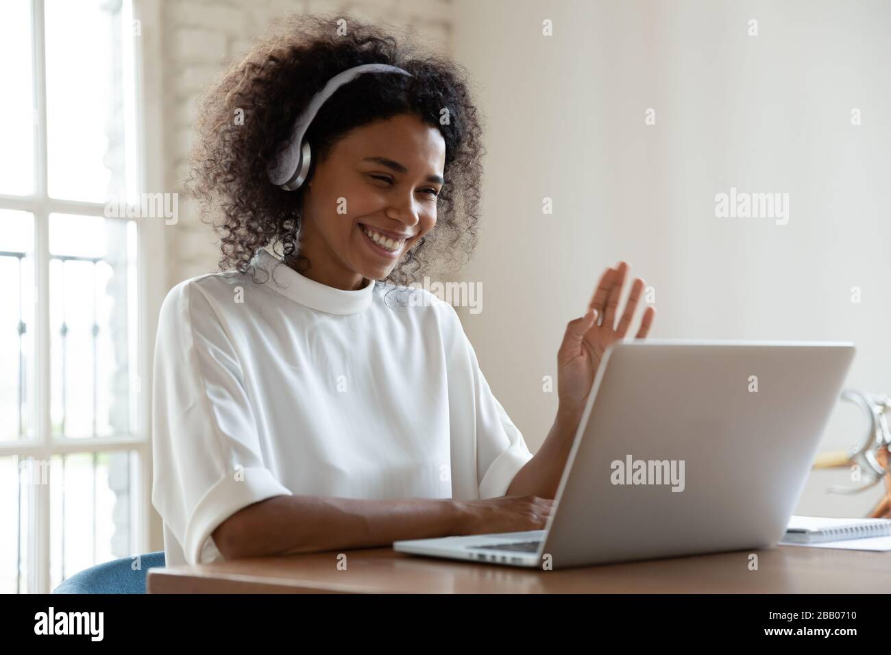 African tutor start online lesson with trainee smiling wave hand Stock Photo