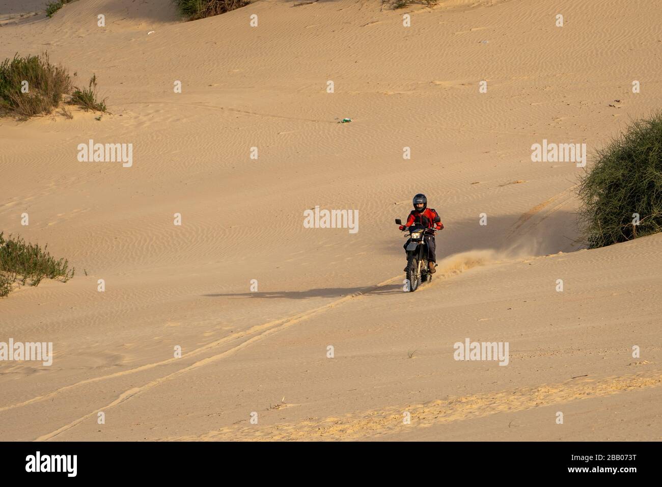 Dirt bike on a sand dune Stock Photo