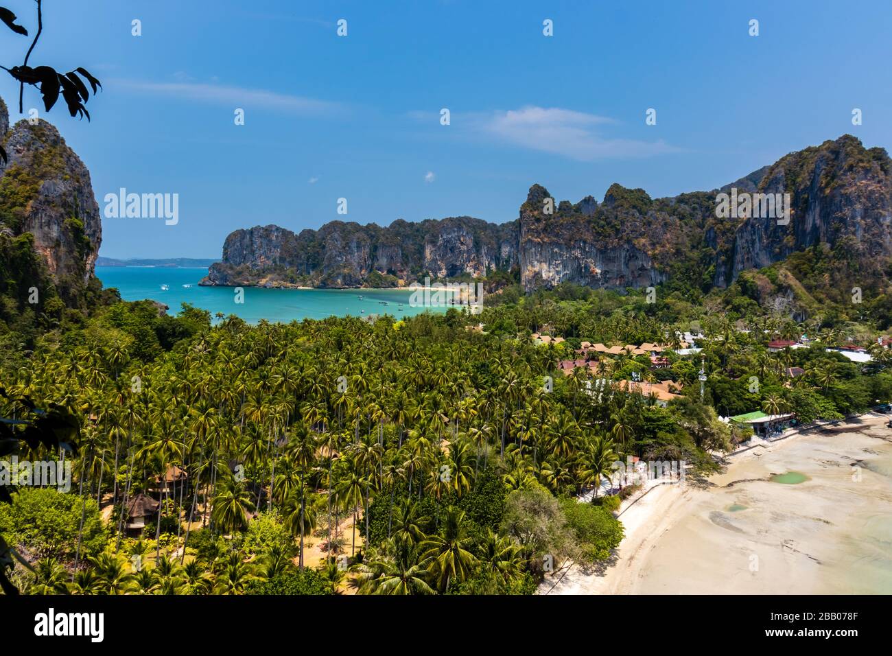 A beautiful tropical view of beaches, lush foliage and towering cliffs (Railay Beach, Thailand) Stock Photo