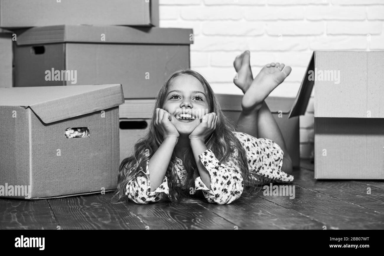 Dreaming about own room. Girl small child and boxes. Move out concept