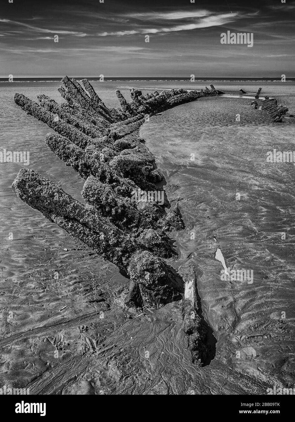 Black and white image of the barnacle encrusted hull of a shipwreck Stock Photo
