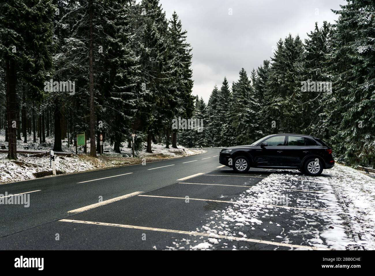 curved wet asphalt road in snowy pine forest Stock Photo - Alamy