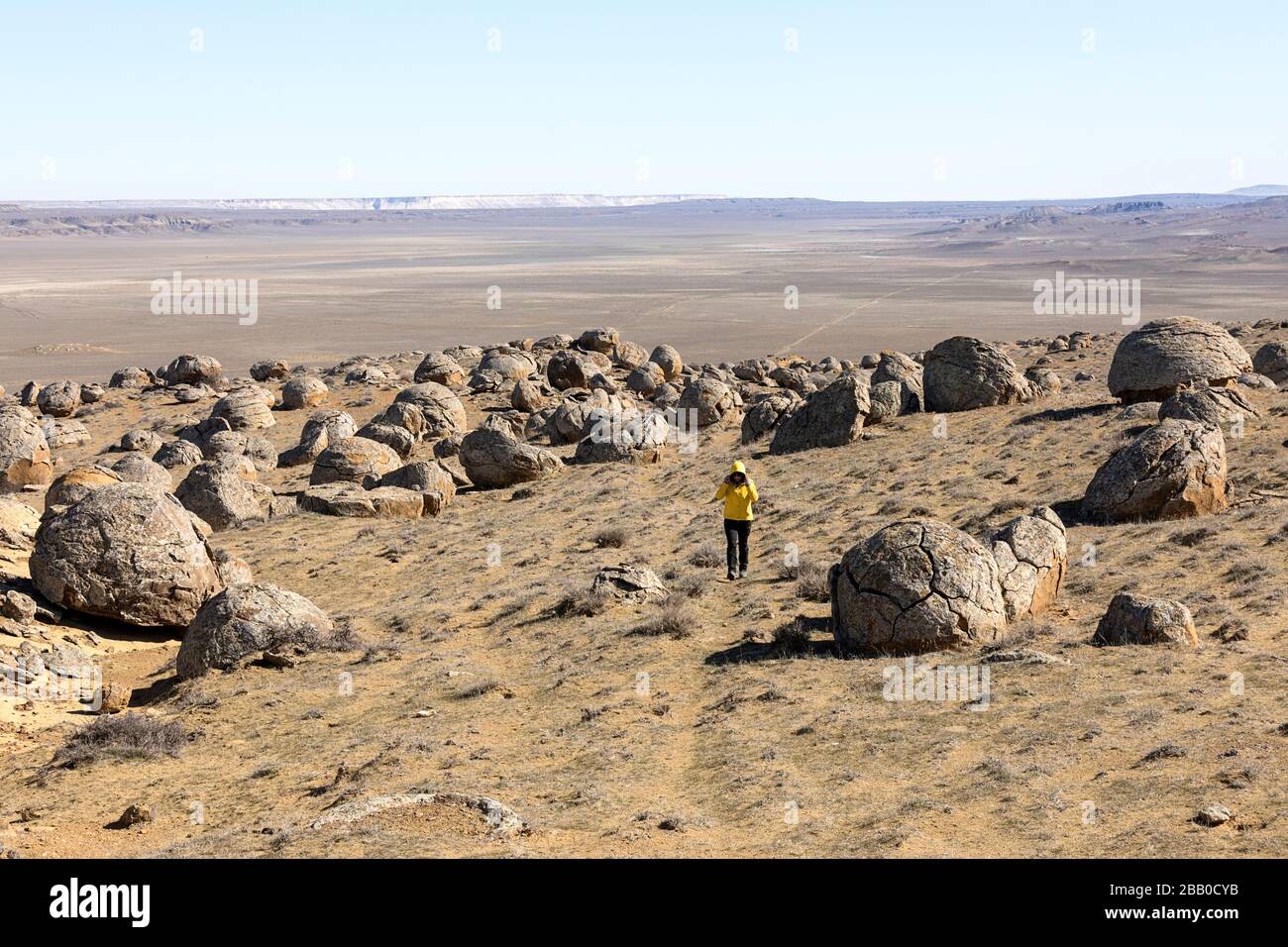 Woman walking in the valley of balls, round rocks, spherical stones in ...