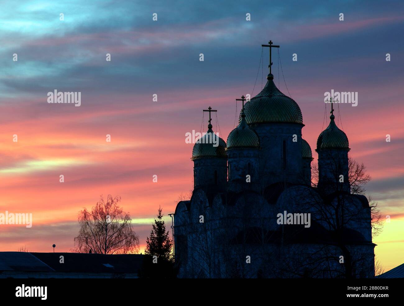 The black silhouette of the monastery against the bright sunset sky. Stock Photo