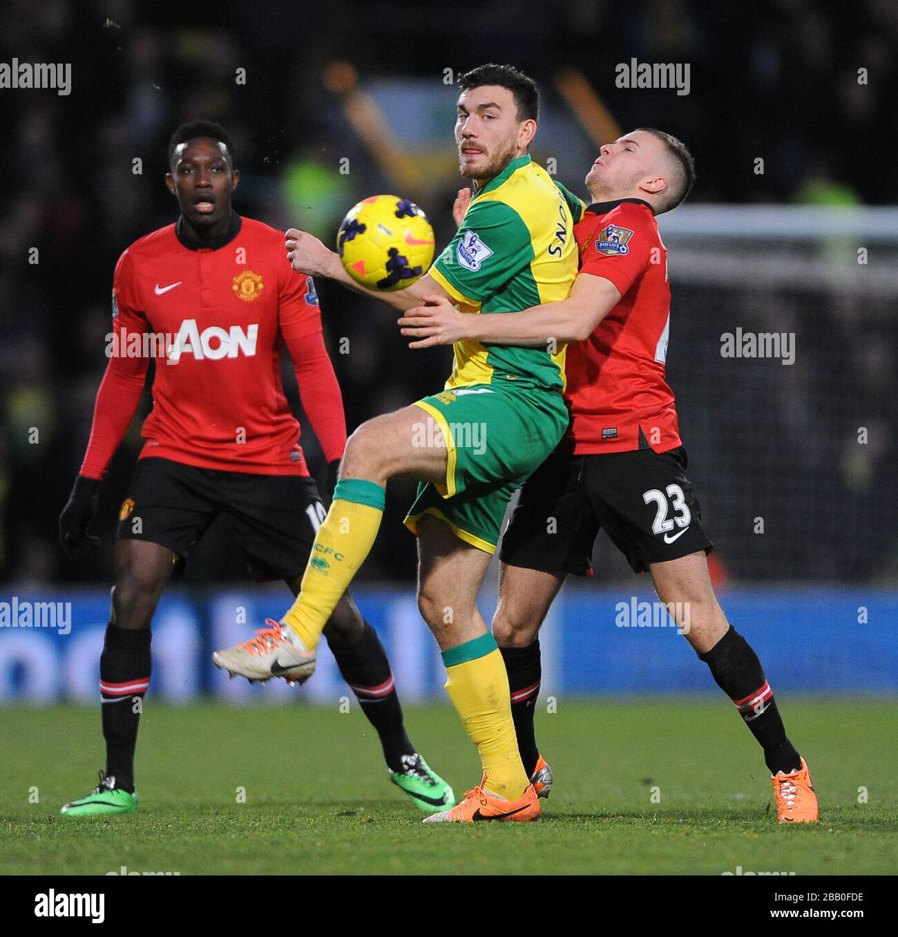 Norwich City's Robert Snodgrass (centre) and Manchester United's Tom Cleverley (right) battle for the ball. Stock Photo