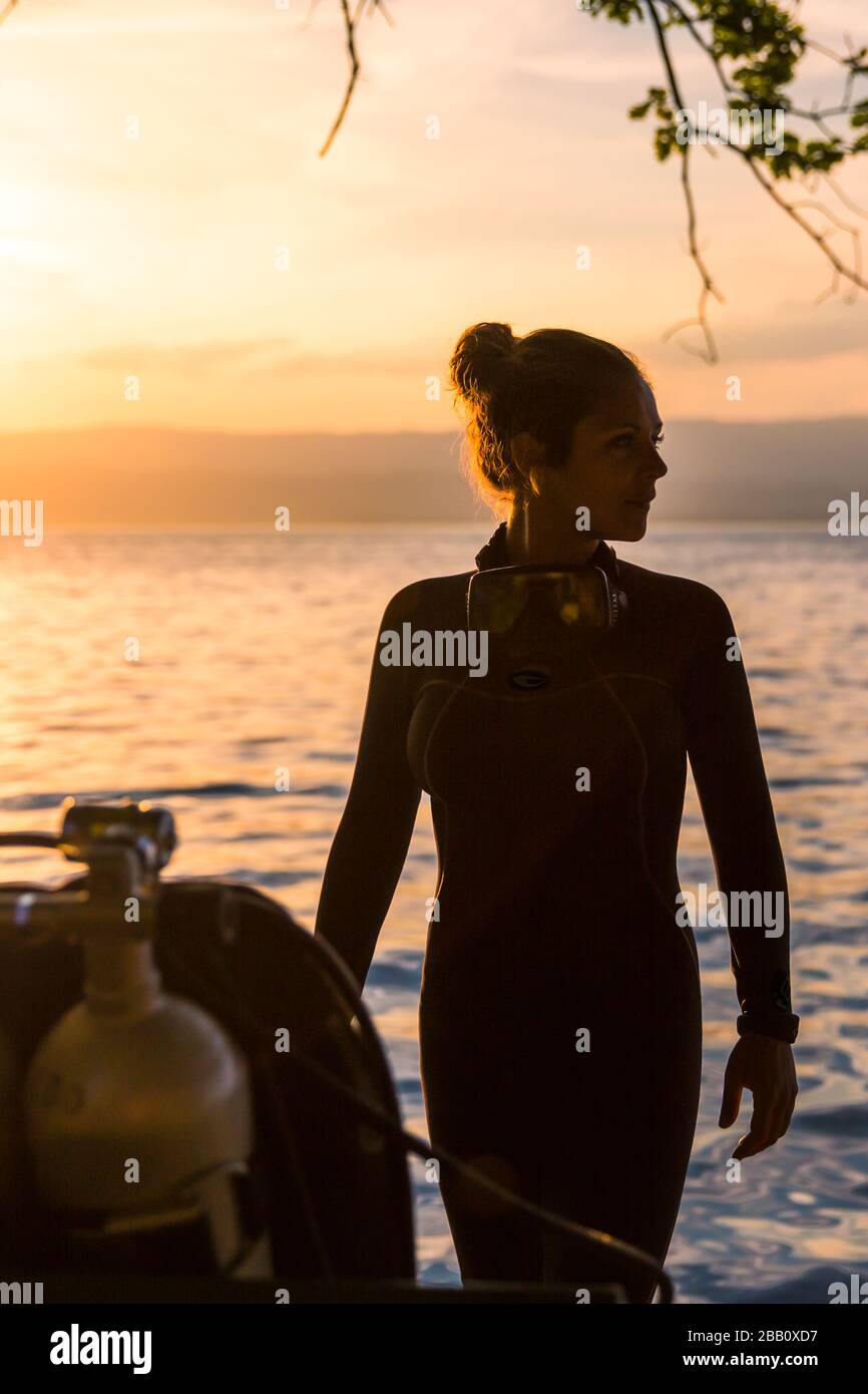 Female Scuba Diving Instructor Wearing a Wet Suit Standing Next to a