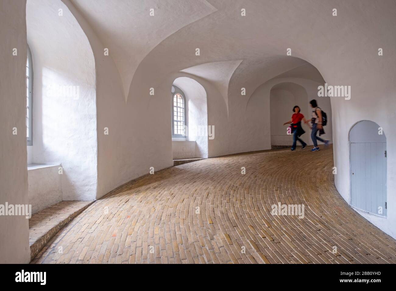 Two tourists descending the equestrian staircase inside the Round Tower aka Rundetaarn in Copenhagen, Denmark, Europe Stock Photo
